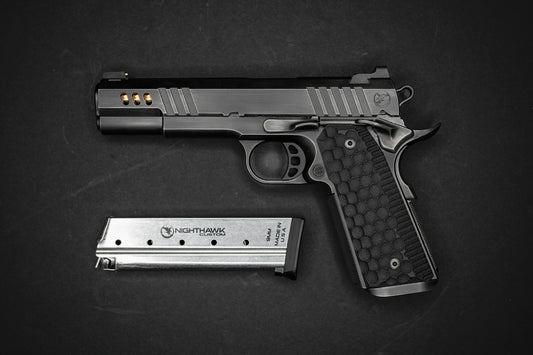 A black semi-automatic pistol with a textured grip and a metal magazine
